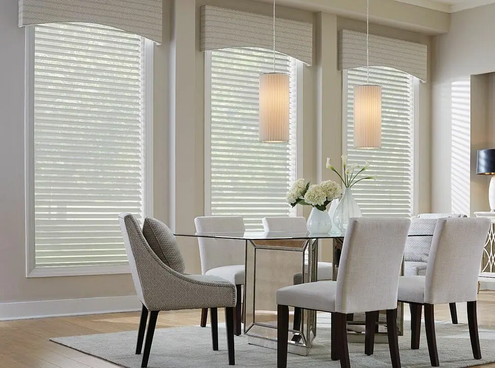 A pair of vinyl blinds that are half drawn to let in gentle light while keeping a modern look.