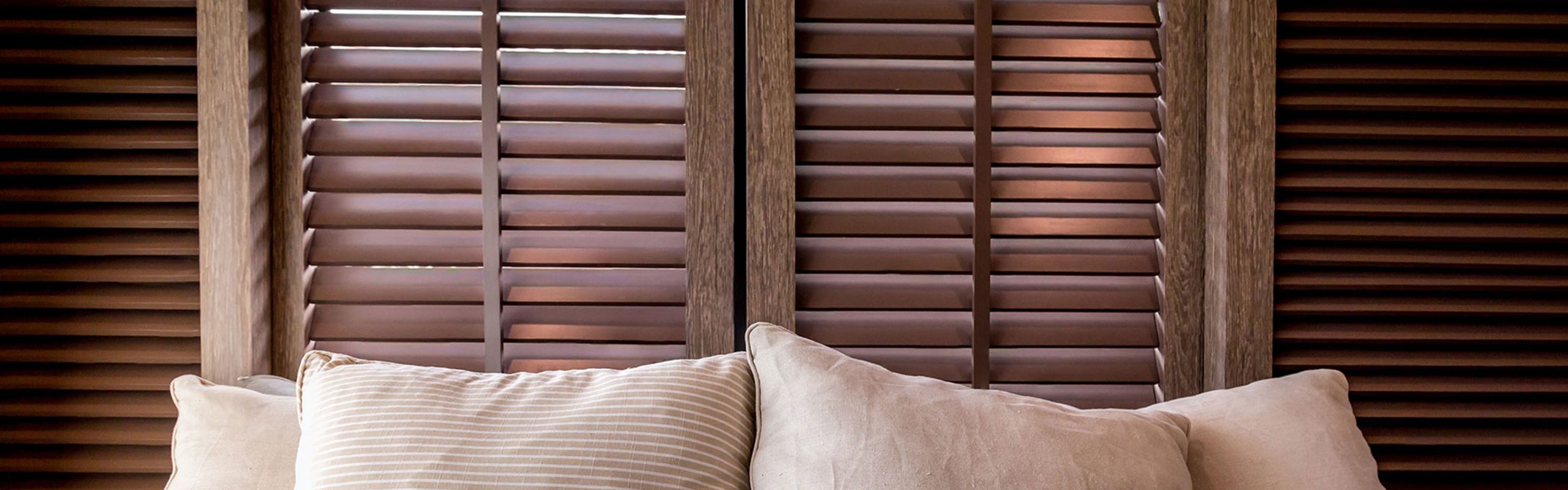 Stylish faux wood blinds that improve the control of natural light in a modern living area.