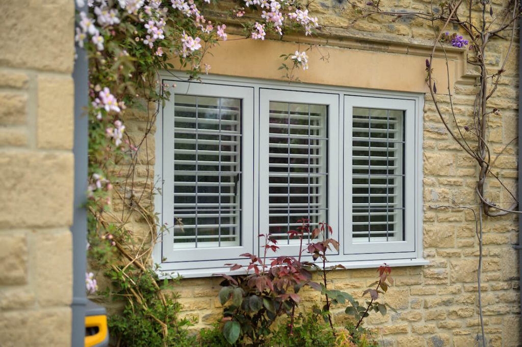 A representation of a worn window shutter with horizontal slats adds to the scene's attractiveness.