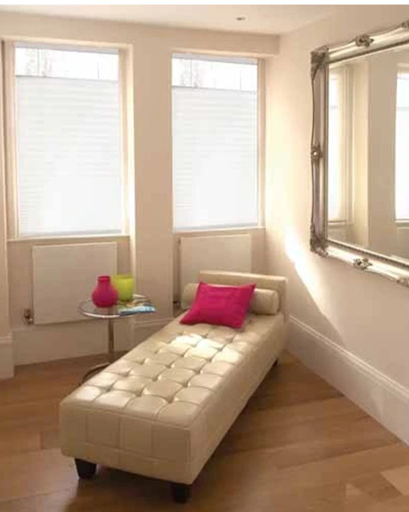 Pleated shades with soft fabric provide texture and flair to the room's decor while beautifully filtering light.