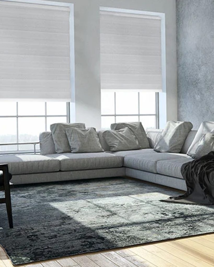 In a contemporary living area, solar shades retain a sleek appearance while filtering sunlight to improve indoor comfort.