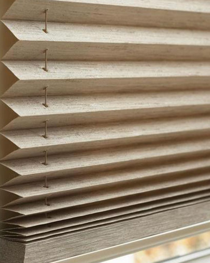 An exquisitely placed gilded blind in a window, showcasing both its practicality and visual appeal.