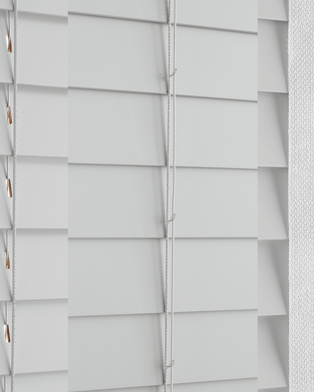 Contemporary faux wood blinds with a stylish, natural wood-like texture that balances light and privacy in a brightly lighted environment.