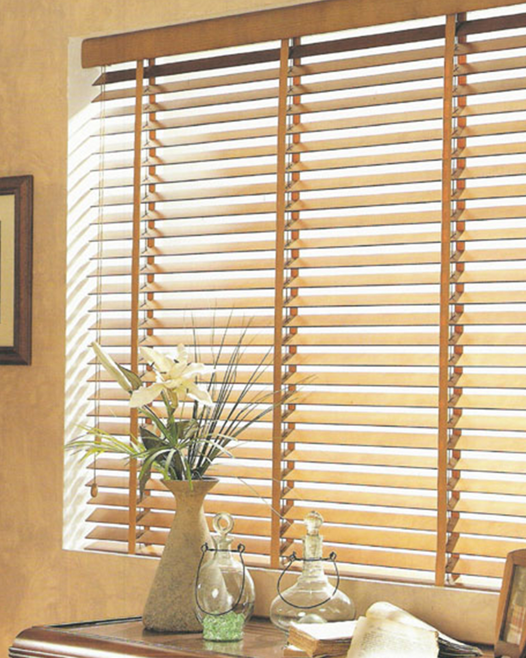 Elegant composite blinds offer seclusion while letting in gentle light in a light-filled environment.