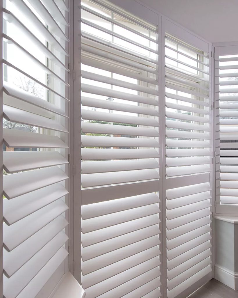 Composite shutters on a home window, exhibiting the ideal balance of robustness and style appeal in a muted hue.
