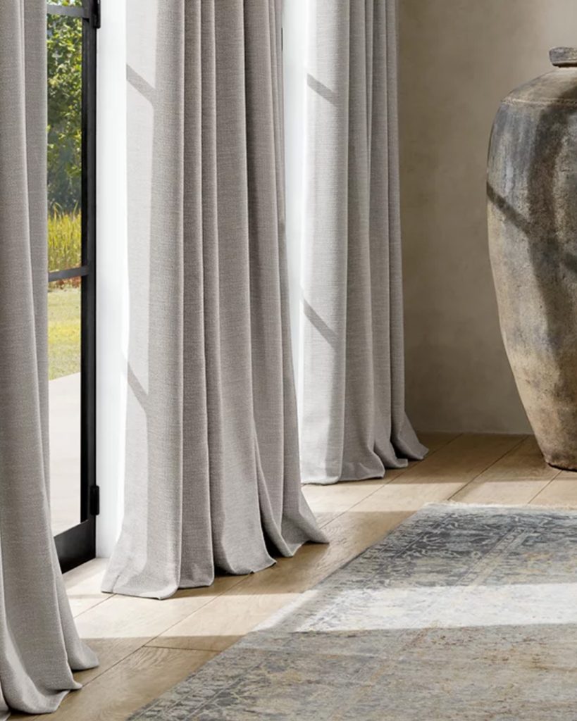 Soft, elegant drapes that beautifully frame a window and add a touch of sophistication to the room's ambience.