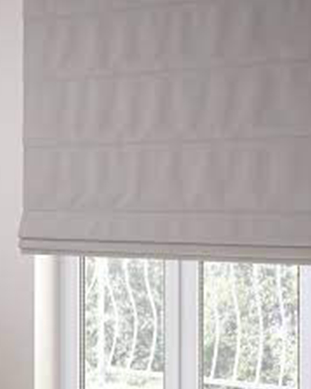 A window is beautifully framed by soft, textured blinds that provide soft light and a calm, peaceful atmosphere.