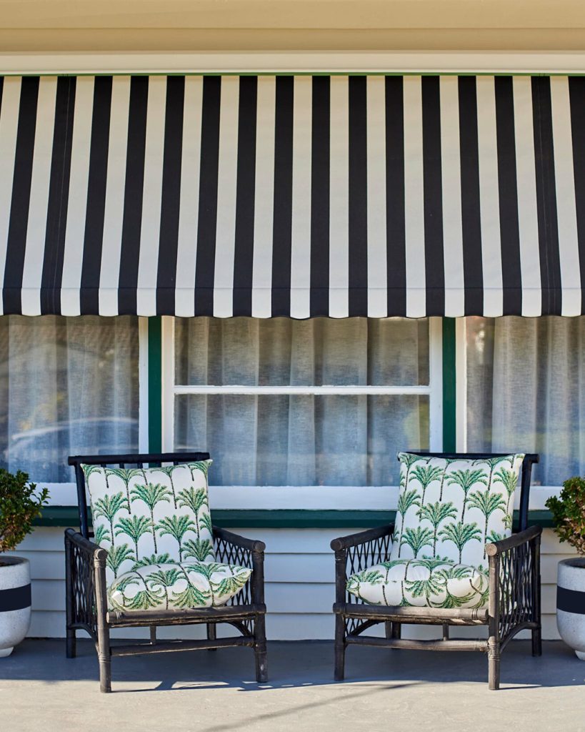 A striking combination of black and white, the window awnings provide visual flair and sun protection.