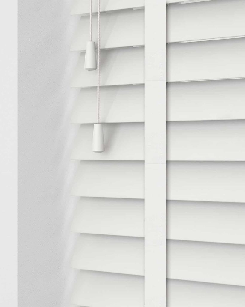 Contemporary white faux wood blinds provide a stylish appearance and efficient light control for a light-filled, welcoming space.