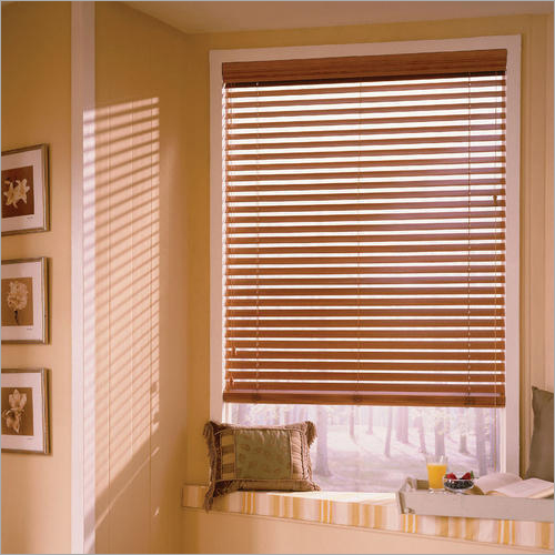 Wood blinds cover a window in style and give the room's decor a cozy, organic look.