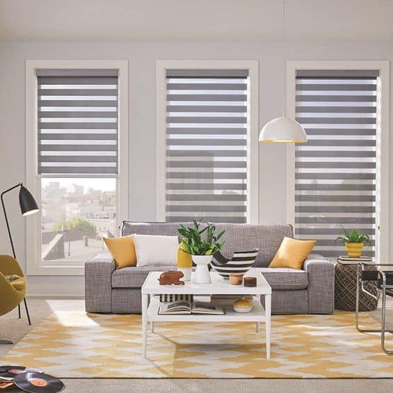 Zebra blinds add a chic and contemporary addition to the room's design by gracefully covering a window.